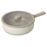 A beige Neoflam Chou Chou 24cm wok with a glass lid and silicon rim, featuring a modern flat handle design on a white background.