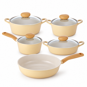 A 5-piece non-stick cookware set in a warm cream-beige color with light brown wooden handles and knobs, including two pots with glass lids, two saucepans, and one deep saute pan, arranged on a white background.