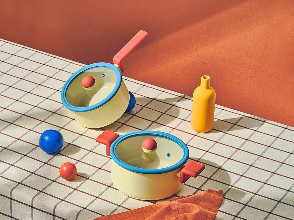 Neoflam Danish yellow stockpot and wok set with blue rims and red handles. Non-toxic Ecolon coating.