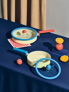 Neoflam Danish yellow stockpot with blue rim and red handle, and matching wok with blue handle. Non-stick ceramic coating.